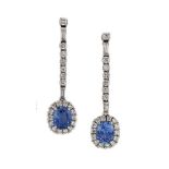 A pair of diamond and sapphire drop earrings, the cushion cut sapphires within claw-set brilliant-