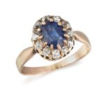 A sapphire and diamond cluster ring, the central claw-set oval sapphire with old-brilliant-cut