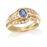 A sapphire and diamond ring, the central collet-set oval sapphire to brilliant-cut diamond triple