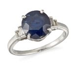 A sapphire single stone ring, the oval sapphire in claw mount to graduated baguette-cut diamond