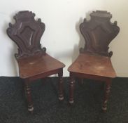 A pair of Victorian mahogany hall chairs