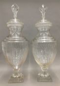 A pair of lidded glass jars