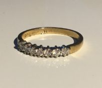 An 18 ct gold seven stone diamond ring