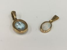 A 9 ct gold aquamarine pendant and a 9 ct gold opal pendant (1.