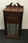 An Edwardian walnut music cabinet. 55 cm wide, 37 cm deep, 108 cm high.