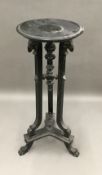 A 19th century ebonised torchere stand,