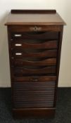 An early 20th century tambour fronted filing cabinet