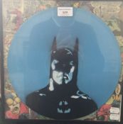 A comic Batman spray painted on vinyl record, framed and glazed.
