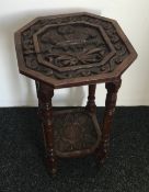 A carved oak side table,