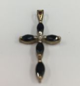 A 9 ct gold diamond and sapphire crucifix (1 gram total weight)