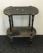 A Victorian ebonised two tier side table