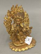 A gilt bronze model of a deity. 13 cm high.