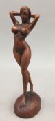 A wooden carving of a nude figure. 18 cm high.