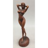 A wooden carving of a nude figure. 18 cm high.