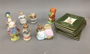 A quantity of Beswick Beatrix Potter figurines and Beatrix Potter books