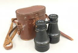 A pair of vintage leather cased field glasses