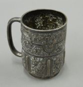 An embossed silver Christening mug (6.