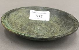 A Chinese shallow bronze dish. 11 cm diameter, 2 cm high.