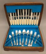 An oak cased canteen of cutlery