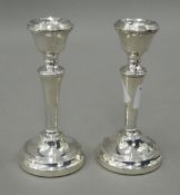 A pair of small silver candlesticks