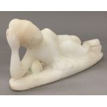 A carved alabaster figure of Buddha modelled reclining