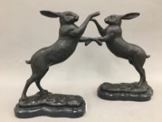 A pair of bronze boxing hares