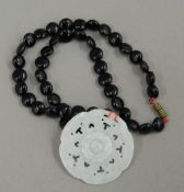 A Chinese jade pendant on necklace