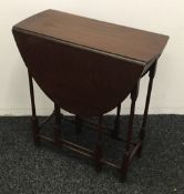 An Edwardian mahogany gate leg table