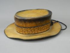 A wide brimmed leather hat - WITHDRAWN Possibly South American. Approximate. Size 58 or 7 1/8th.