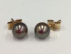 A pair of 9 ct gold and black pearl earrings