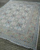 A Persian wool carpet Centred with floral motif filled geometric panels. 315 x 260 cm.