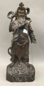 A Chinese carved rosewood model of a deity