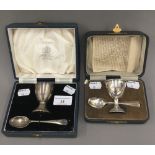 Two cased silver egg cup and spoons (3 troy ounces)