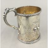 An embossed silver Christening mug (5.