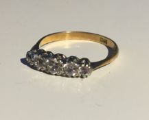 An 18 ct gold five stone diamond ring