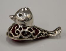 A silver pin cushion formed as a duck