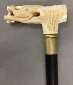 A bone handled walking stick, the top formed as a bird. 93 cm long.