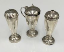 A three piece silver plated cruet set