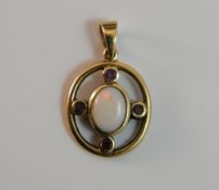 A 9 ct gold opal and ruby pendant (2.
