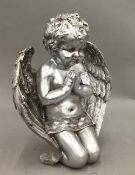 A silver coloured model of a cherub