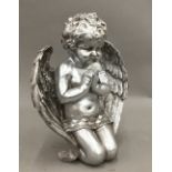 A silver coloured model of a cherub