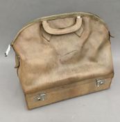 A vintage leather Gladstone bag