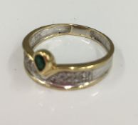 An 18 ct yellow and white gold diamond and emerald ring (4.