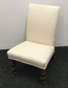 A Victorian upholstered nursing chair and a mahogany side table