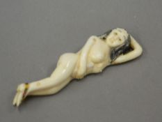 An Oriental bone medical figure. 9 cm long.