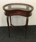A Victorian inlaid mahogany kidney shaped bijouterie cabinet