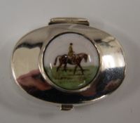 A silver pill box depicting a horse