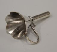 A miniature silver funnel