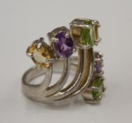 A silver multi-stoned dress ring