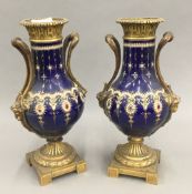 A pair of gilt bronze mounted porcelain vases. 29.5 cm high, 16 cm at their widest.